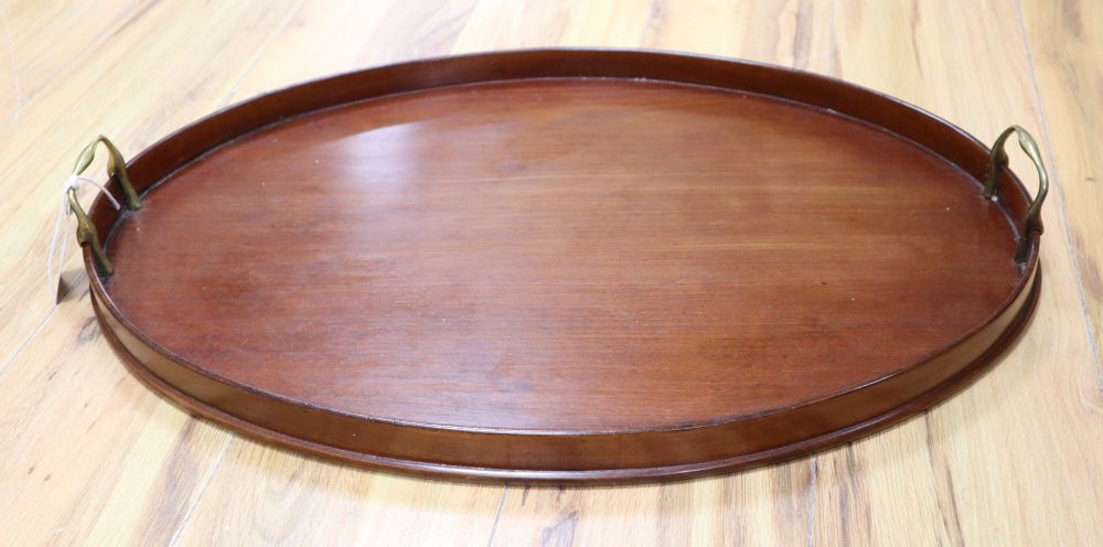 An oval wooden tray fitted brass handles, 62cm